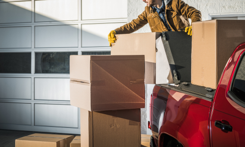 Man putting boxes on the back of truck